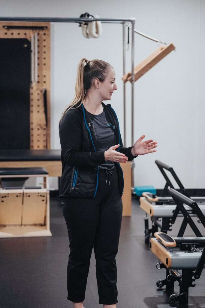 instructor encouraging pilates class